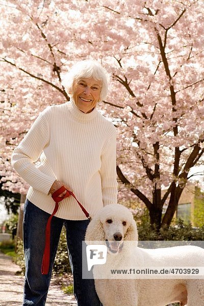 Portrait of senior woman with dog