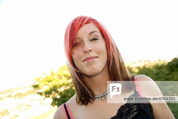 Young woman with dyed hair smiling