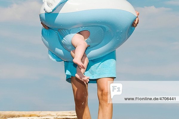 Mother carrying baby in float