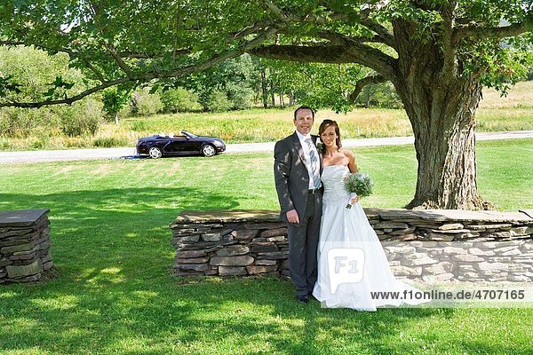Newlywed couple standing in a park  East Meredith  New York State  USA