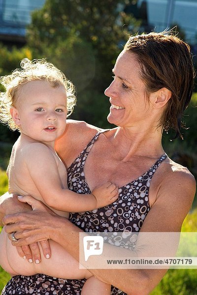 Woman carrying her baby girl