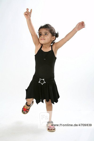 young girl of 4 years happy standing and bending from knees and looking up MR 687D