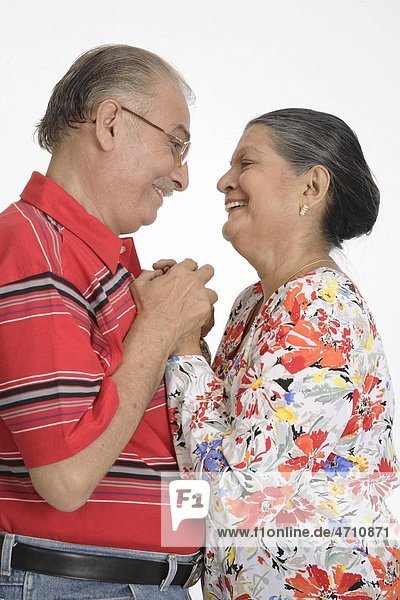 Old couple old man and woman standing facing each other and holding hands MR 703B and 703A