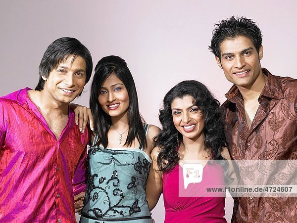 South Asian Indian men and women standing together in party MR
