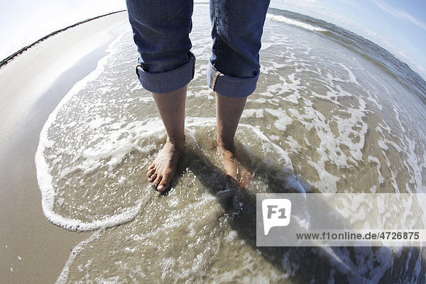 Feet in the sea  beach  Langeoog island  East Frisian Islands  North Sea  Germany  Europe