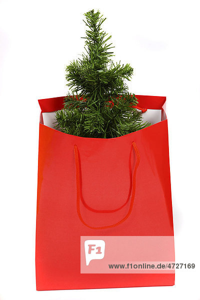 Gift bag with a small plastic Christmas tree  Christmas shopping