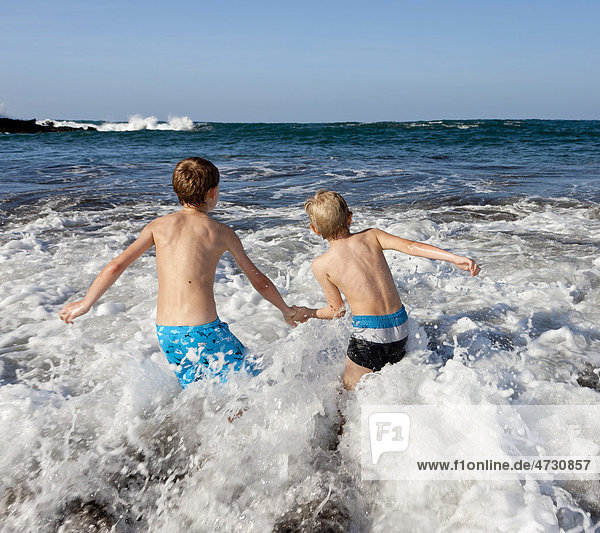 Children playing in the surf  Playa Jardin beach  Puerto de la Cruz  Tenerife  northern part  Canary Islands  Spain  Europe