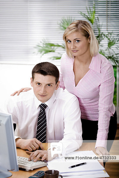 Young businessman and businesswoman in the office