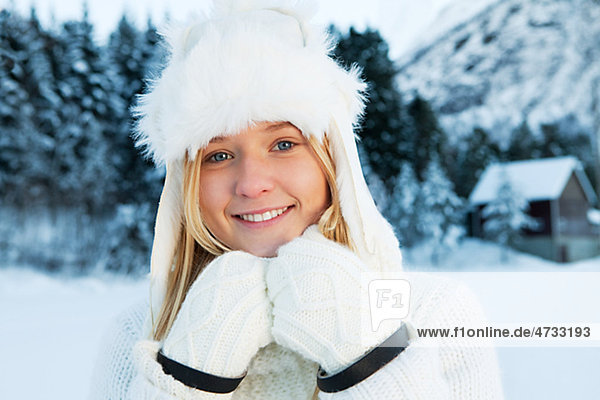 Portrait of teenage girl in white winter clothing