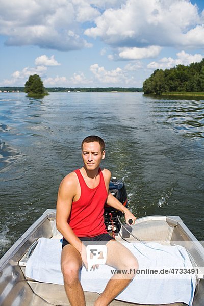 Young man on motorboat