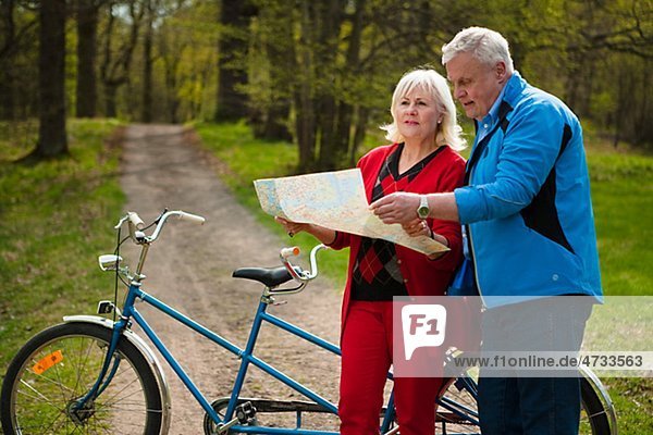 älteres Paar mit Tandem-Fahrrad