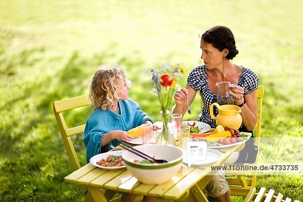 Außenaufnahme Tochter essen essend isst Mutter - Mensch freie Natur