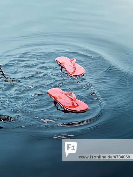Flip flops floating on water