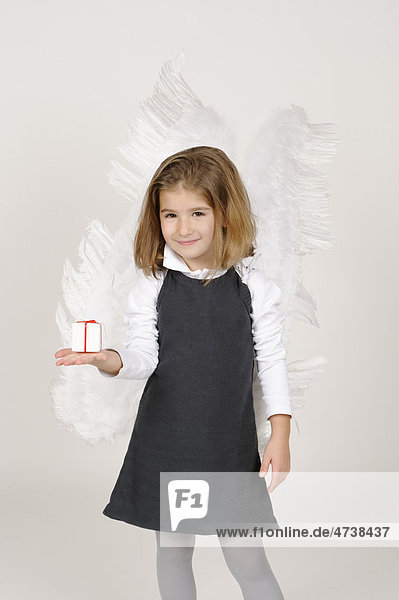 Girl with angel wings with Christmas present