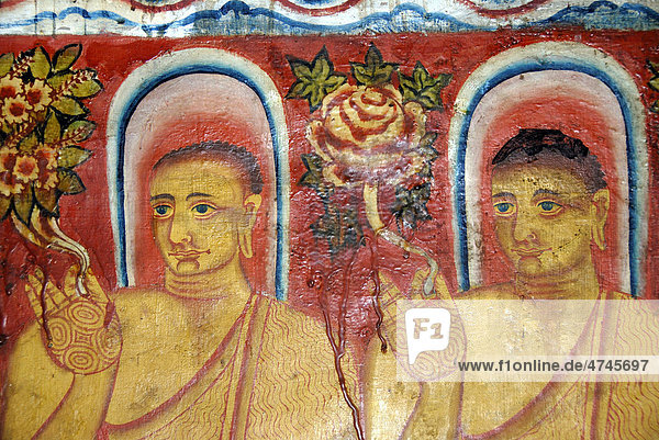 Theravada Buddhism  old mural  Buddhas with halos holding flowers in their hands  Mulgirigala temple  Mulkirigala  Ceylon  Sri Lanka  South Asia  Asia