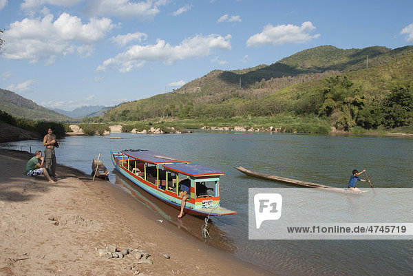 Tourist boat at rest on the river Nam Ou at Nong Khiao Khiaw Nong Luang Prabang province Laos Southeast Asia Asia