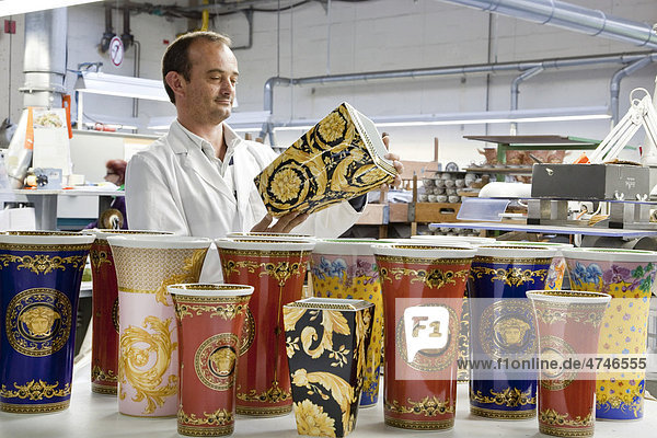 Final inspection of a Versace vase after polishing the gold at the porcelain manufacturer Rosenthal GmbH  Speichersdorf  Bavaria  Germany  Europe