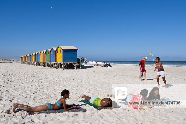 Young people sunbathing on the beach of Muizenberg  Western Cape  South Africa
