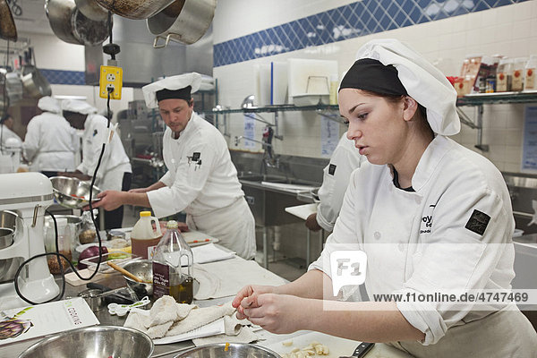 A student prepares food at the Dorsey Culinary Academy  a private career training school  Roseville  Michigan  USA