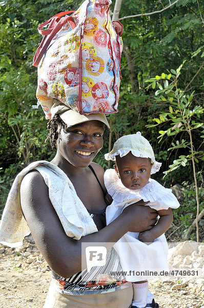 Portrait of a mother and child  mother with a bag on her head  Petit Goave  Haiti  Caribbean  Central America