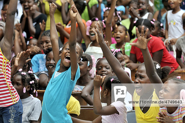 Cheering children during a theatre play at school  Petit Goave  Haiti  Caribbean  Central America