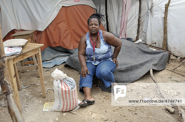 Woman sitting on her bed in a tent camp for victims of the January 2010 earthquake  Delmas 89 district  Port-au-Prince  Haiti  Caribbean  Central America