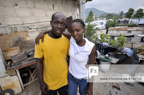 Couple standing in front of their house  Delmas 89 district  Port-au-Prince  Haiti  Caribbean  Central America
