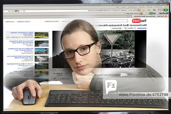 Young woman sitting at a computer surfing the Internet  viewing a video on the YouTube site  view from within the computer  symbolic image
