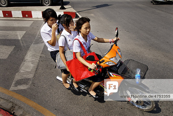 Three girls on a motorcycle in Chiang Mai  Thailand  Asia