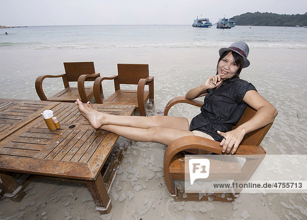 Woman sitting on a flooded beach  Koh Samet  Thailand  Asia