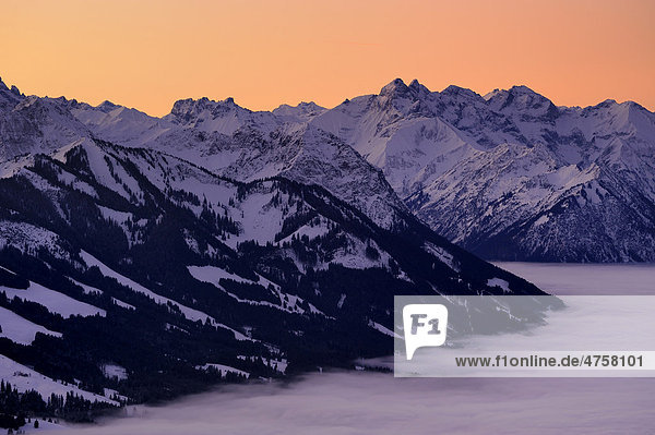 Sunrise above mountain tops with fog in winter  Sonthofen  Allgaeu  Bavaria  Germany  Europe