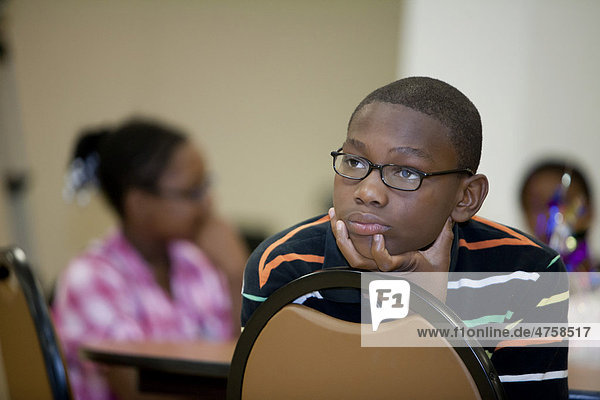 A boy listens to a teacher at a Summer Literacy Camp organized by the American Federation of Teachers for school children in Detroit  Michigan  USA