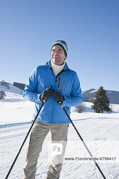 Smiling man in winter landscape  Tannheimer Tal  Tyrol  Austria