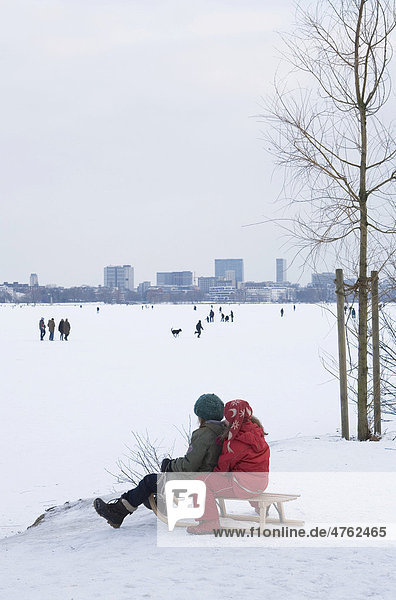 Children tobogganing on the frozen Alster Lake  Hamburg  Germany  Europe