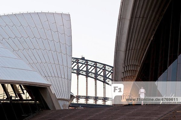 Woman walking down stairs at Sydney Opera House  Sydney  NSW  Australia