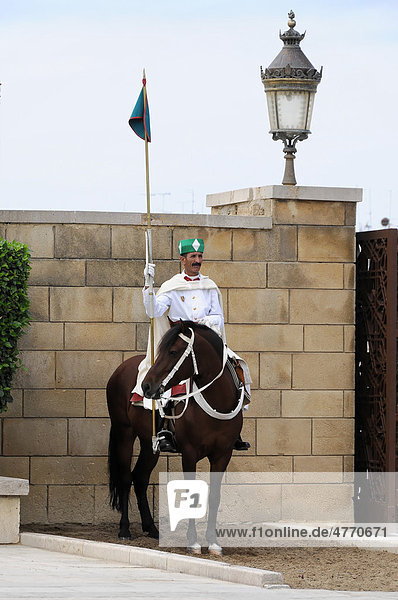 Mounted guard wearing a traditional uniform in front of the entrance to the Mausoleum of Mohammed V and Hassan II  Rabat  Morocco  Africa