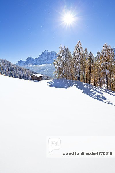 Haystack in snowy mountain landscape Sexten Alto Adige Italy