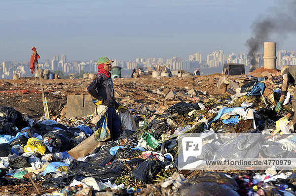 Young man searching for recyclables at the Lixao dump in the satellite city of Estrutural near Brasilia  Distrito Federal  Brazil  South America