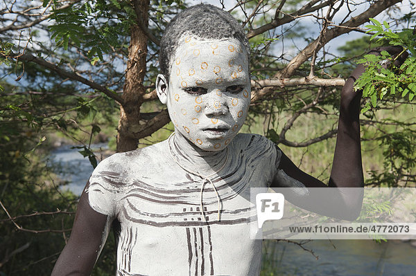 Surma boy with facial and body painting,  Kibish,  Omo River Valley,  Ethiopia,  Africa