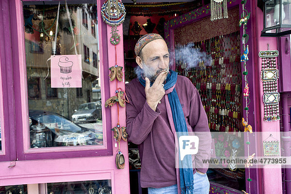 Shop keeper smoking outside his shop in Istanbul  Turkey