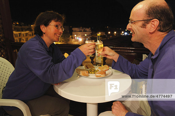 Paar auf Balkon prostet sich mit Weißwein zu  La Playa  Valle Gran Rey  La Gomera  Kanaren  Spanien  Europa Insel La Gomera