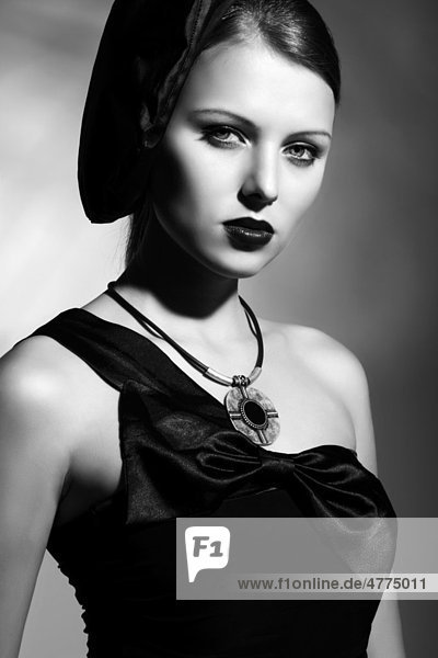 Young woman wearing an elegant black dress and hat  portrait  black and white
