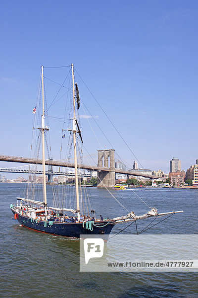 Sailing ship in front of Brooklyn Bridge  New York  USA