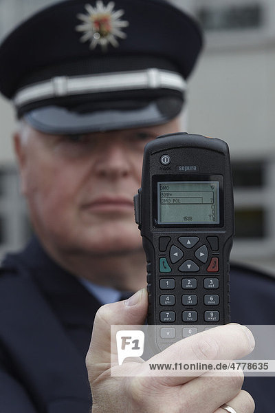 Police officer displaying a new digital radio which is currently being tested by the Rhineland-Palatinate police  Koblenz  Rhineland-Palatinate  Germany  Europe
