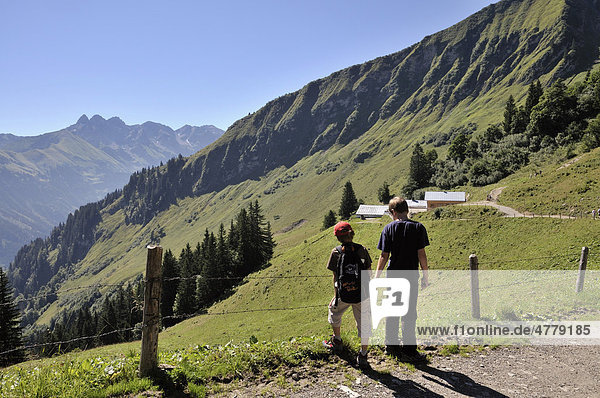 Two hiking boys  Soellereck  in the back the main ridge of the Allgaeu Alps  Bavaria  Germany  Europe