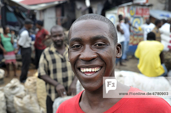Smiling young man  portrait  urban market of Des Croix Bossales in the port district of La Saline  Port-au-Prince  Haiti  Caribbean  Central America