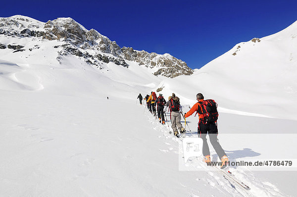 Ski mountaineers en route to Mt Piz Tasna  Engadin  Grisons  Switzerland  Europe