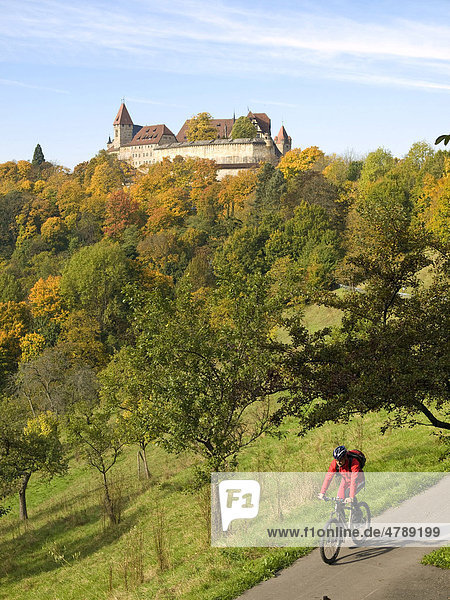 Cyclists in front of the Veste Coburg castle  Coburg  Upper Franconia  Franconia  Bavaria  Germany  Europe