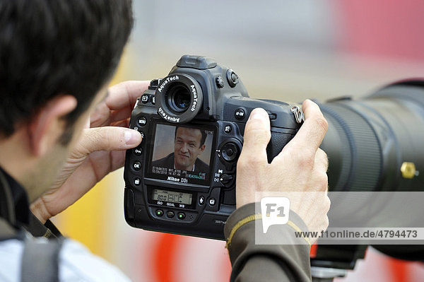 Fredi Bobic  manager of VfB Stuttgart  in the focus of the press  press photographer  Nikon D3S  Nikon AF-S VR 400-2  8
