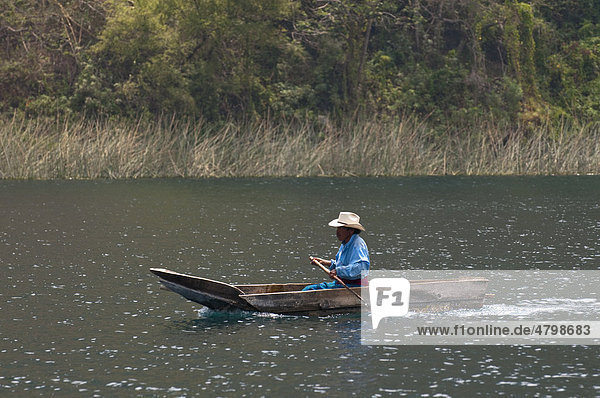 Fisherman on Lago de Atitlan lake  Guatemala  Central America